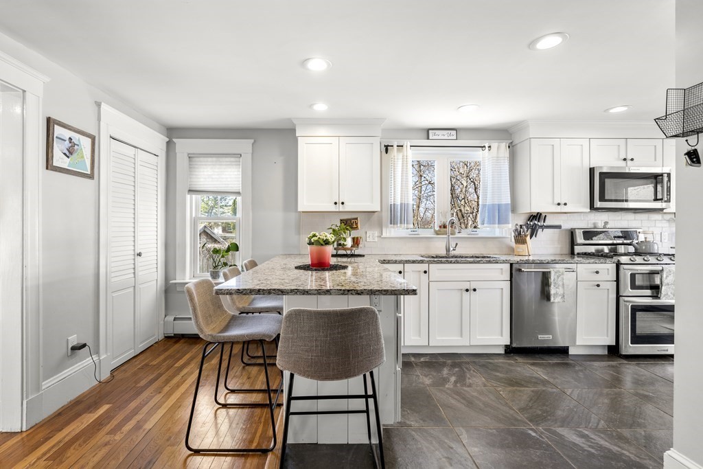 222 Windsor Avenue Swampscott, MA 01907 - Photo 11 of 36 a kitchen with white cabinets and stainless steel appliances
