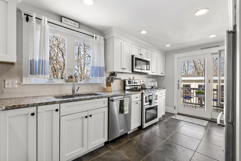 222 Windsor Avenue Swampscott, MA 01907 - Photo 12 of 36 a kitchen with stainless steel appliances granite countertop a stove top oven a sink a counter top space and cabinets