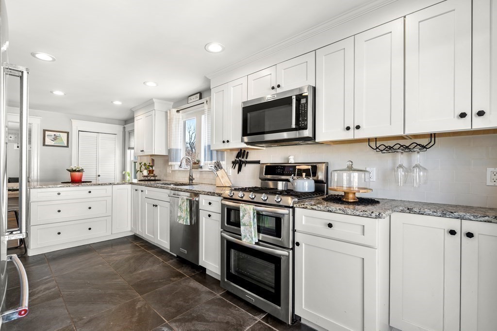 222 Windsor Avenue Swampscott, MA 01907 - Photo 15 of 36 a kitchen with granite countertop white cabinets and stainless steel appliances