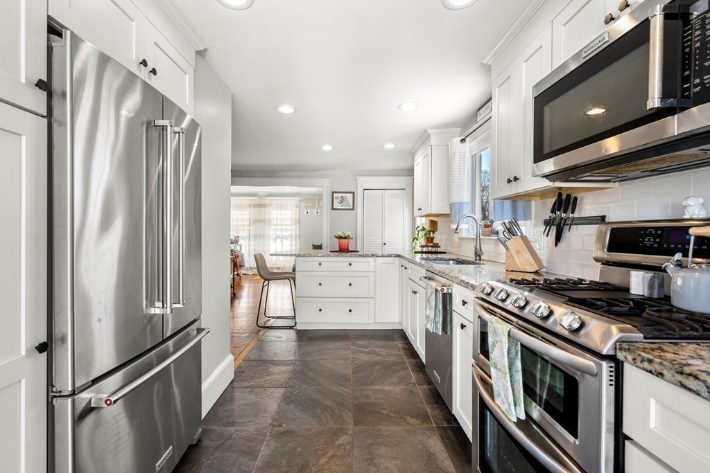 222 Windsor Avenue Swampscott, MA 01907 - Photo 16 of 36 a kitchen with stainless steel appliances granite countertop a refrigerator a stove and a sink