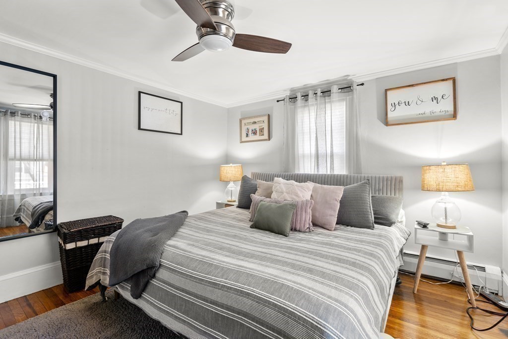 222 Windsor Avenue Swampscott, MA 01907 - Photo 20 of 36 a bedroom with a bed and a lamp on dresser with wooden floor