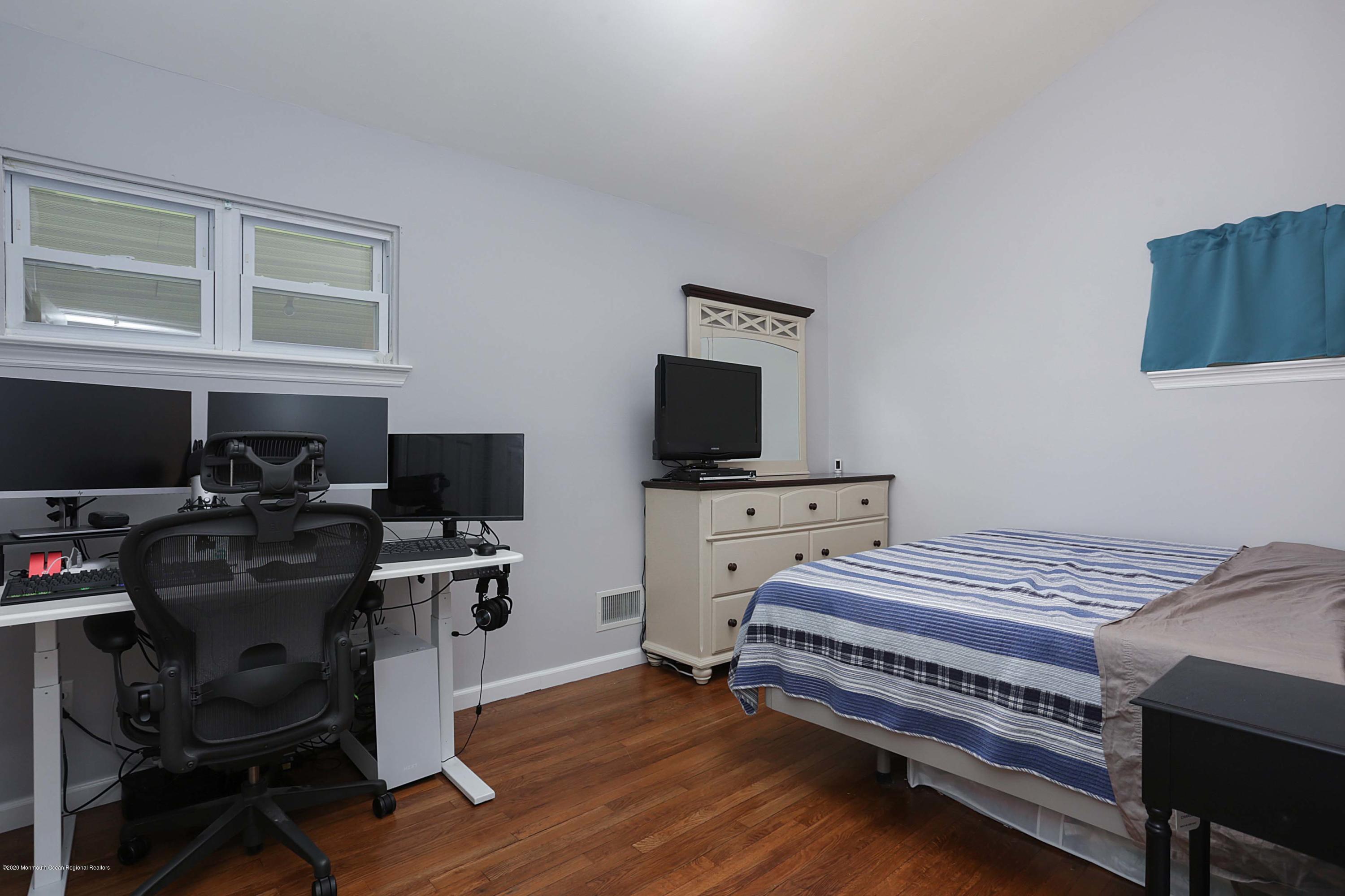 271 Middle Road Hazlet, NJ 07730 - Photo 7 of 11 a bedroom with a bed and a flat screen tv