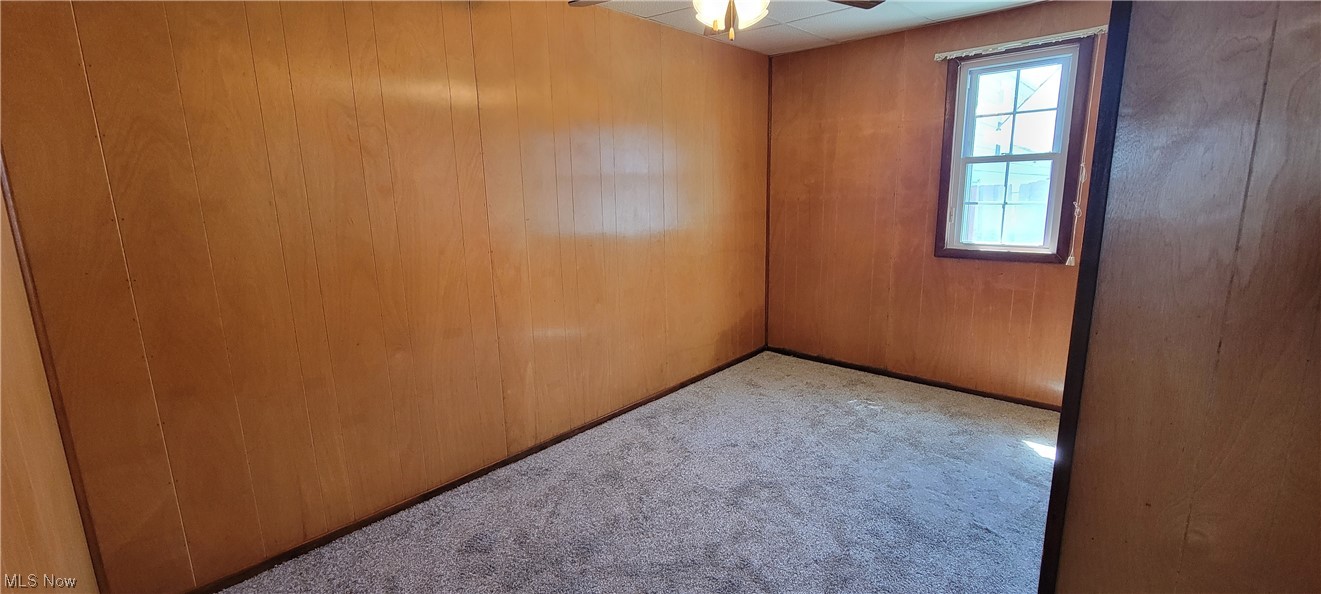 33703 Guilbert Road Eastlake, OH 44095 - Photo 21 of 32 Spare room with wooden walls and light carpet