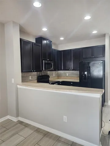 a view of kitchen with cabinets and stainless steel appliances