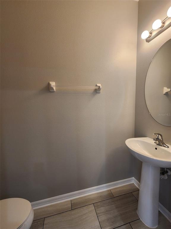 7010 Spotted Deer Place Riverview, FL 33578 - Photo 8 of 21 a bathroom with a sink toilet and a mirror