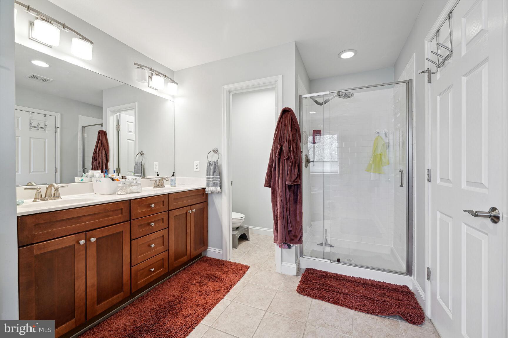 1907 Kermit Road Silver Spring, MD 20910 - Photo 14 of 20 a spacious bathroom with a double vanity sink and a mirror
