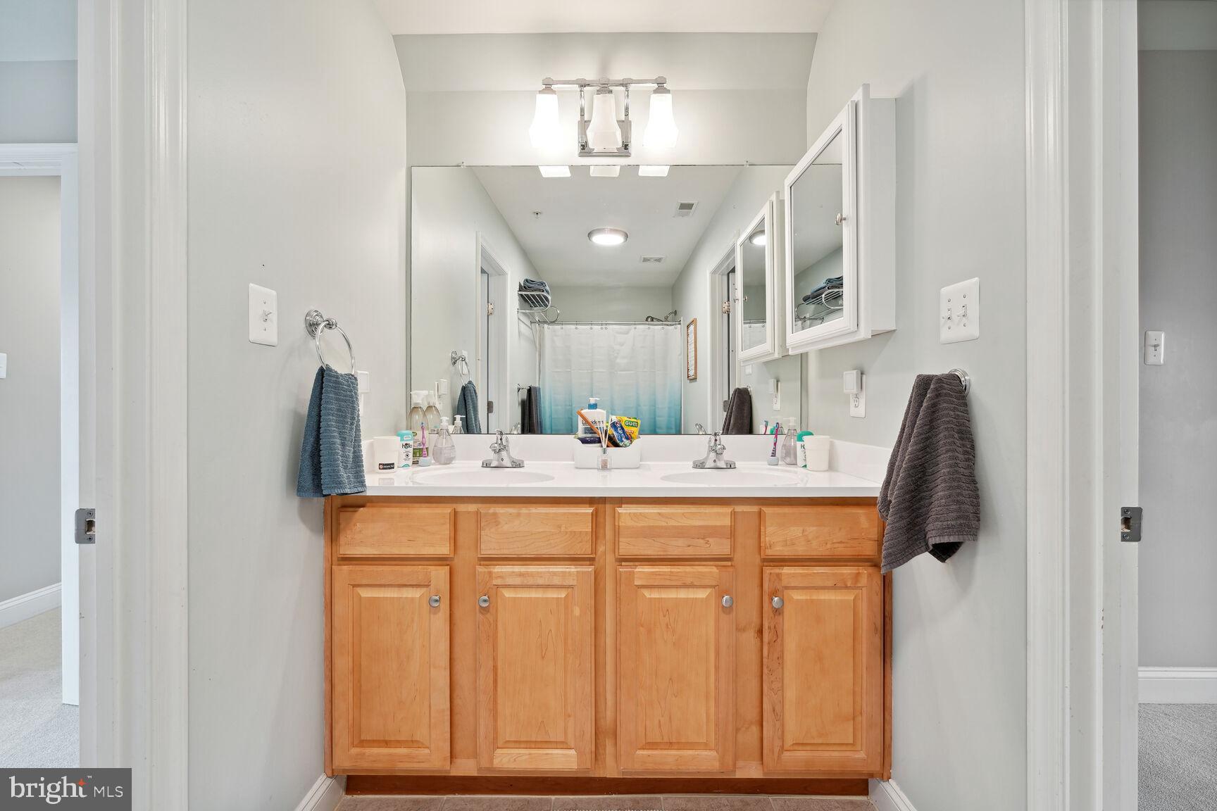 1907 Kermit Road Silver Spring, MD 20910 - Photo 15 of 20 a spacious bathroom with a granite countertop sink and a mirror