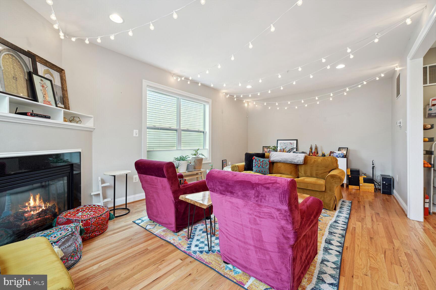 1907 Kermit Road Silver Spring, MD 20910 - Photo 4 of 20 a living room with furniture a fireplace and a dining table with wooden floor