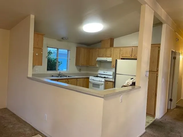 a kitchen with stainless steel appliances sink refrigerator and microwave