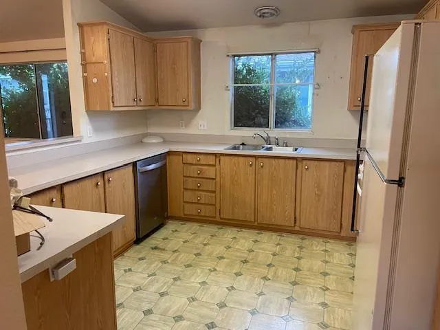 a kitchen with sink cabinets and window
