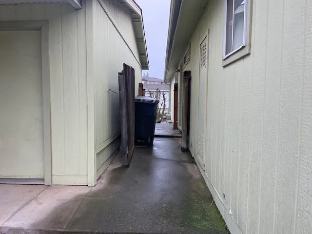a view of hallway with a refrigerator