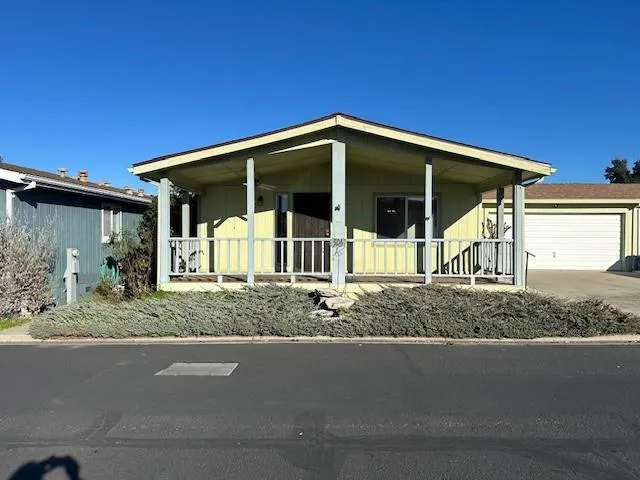 a view of a house with a yard and garage