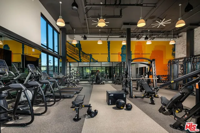 a view of gym with large windows