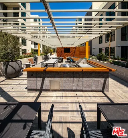 a view of a patio with a table and chairs