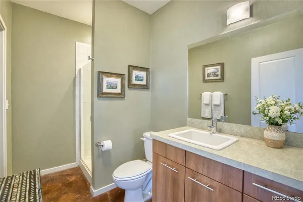 a bathroom with a sink toilet and a mirror