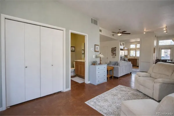 a living room with furniture and a view of bathroom