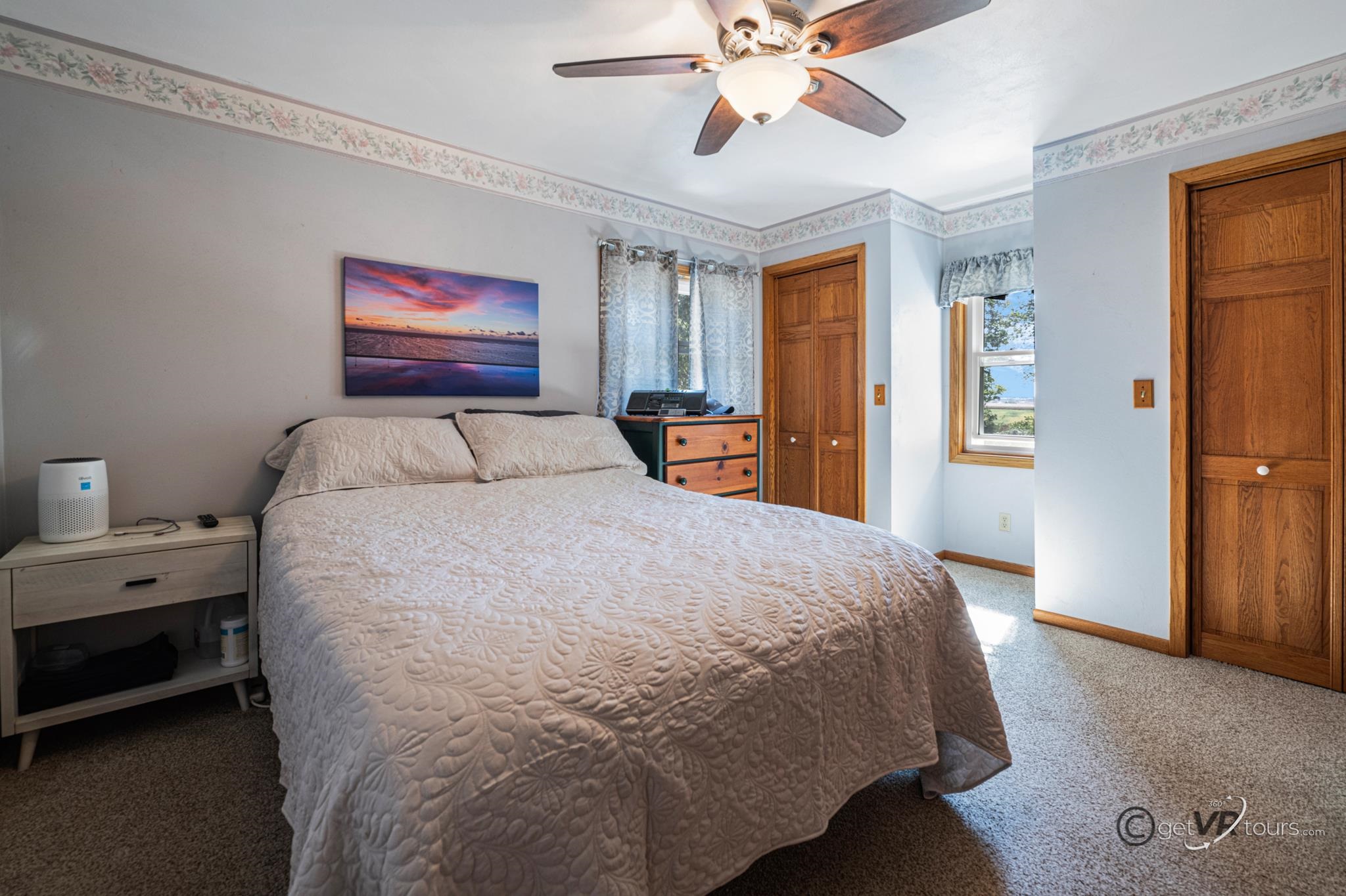 2472 West Red Oak Road Freeport, IL 61032 - Photo 17 of 45 a bedroom with a large bed and a chandelier