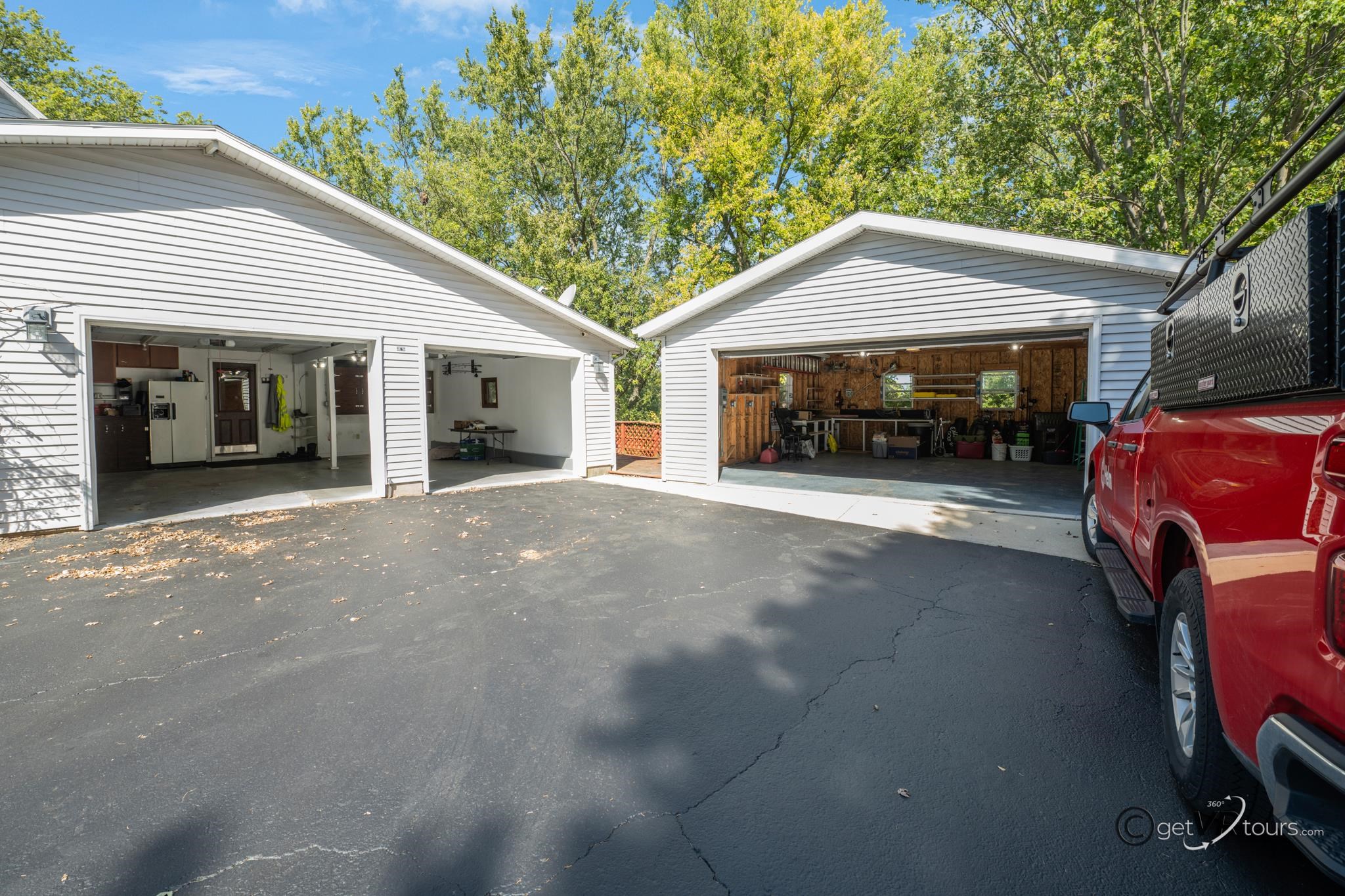 2472 West Red Oak Road Freeport, IL 61032 - Photo 25 of 45 a view of a house with a barbeque and large trees
