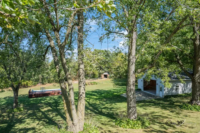 a view of a house with large space and a car parked in front of it