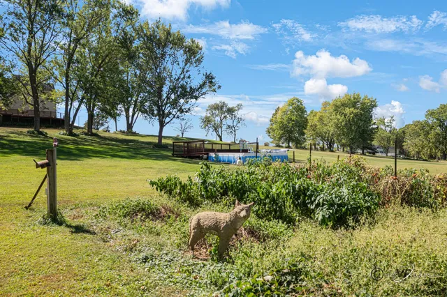 a view of a house with backyard and sitting area