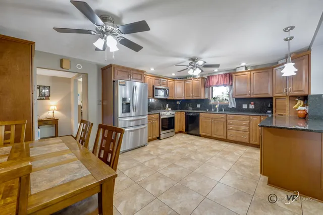 a large kitchen with cabinets and stainless steel appliances