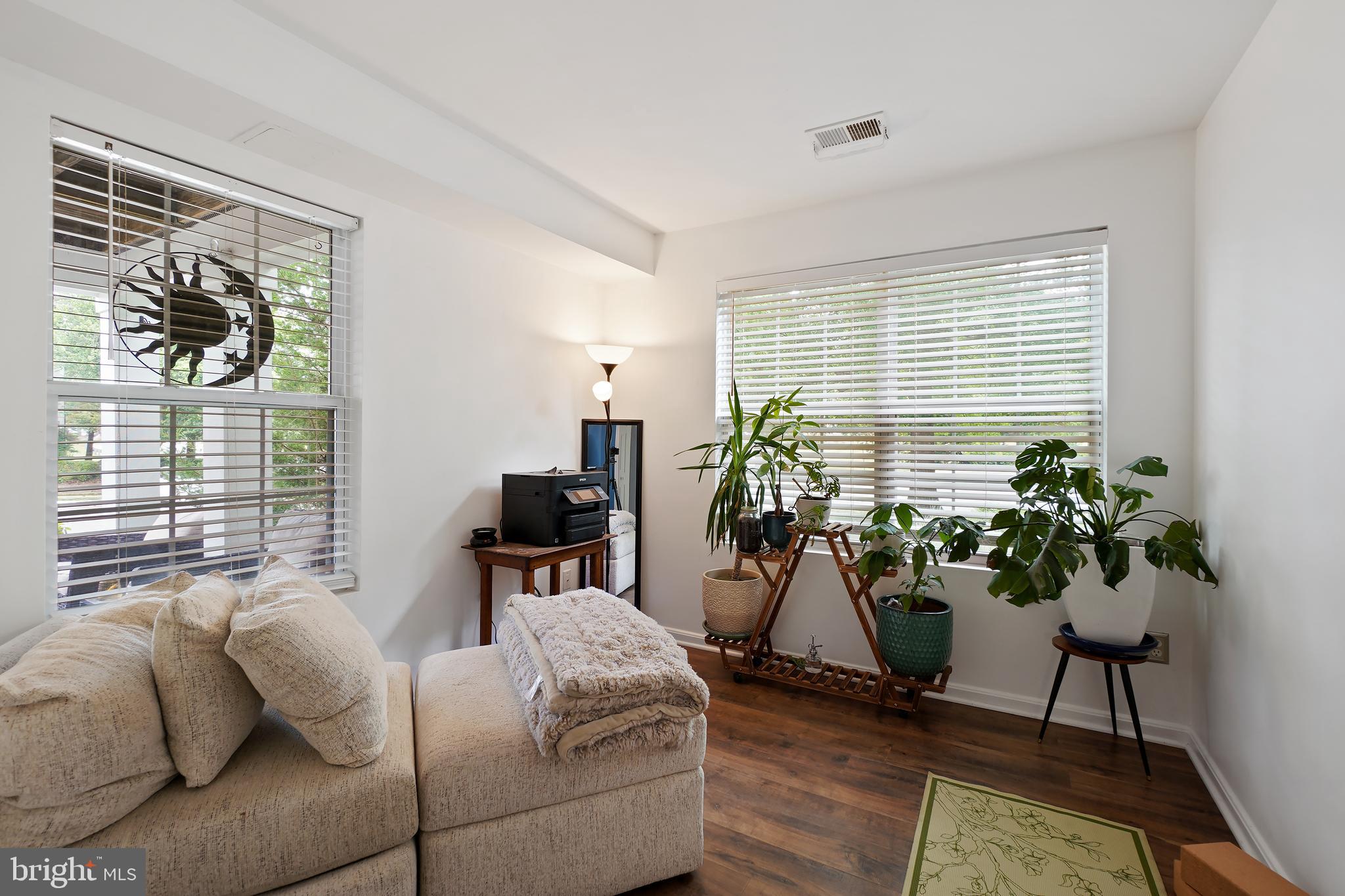 14151 Cuddy Loop, Unit 101 Woodbridge, VA 22193 - Photo 9 of 45 a living room with furniture potted plant and a window