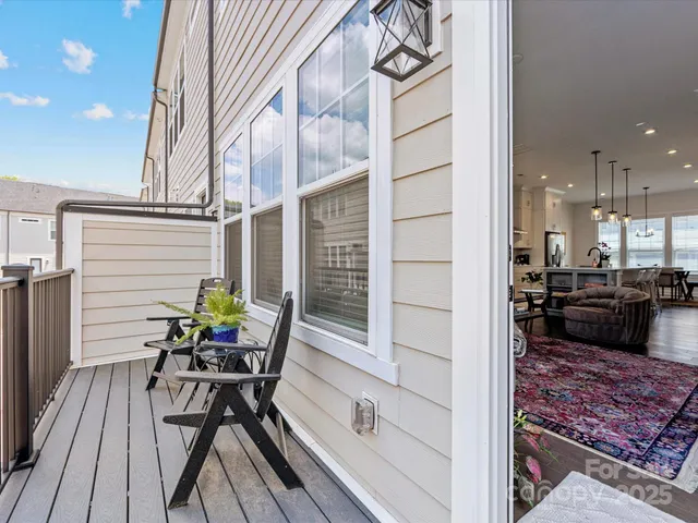 a view of a chairs and table in the balcony