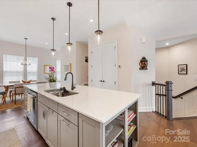 a kitchen with a stove a refrigerator a sink a dining table and chairs