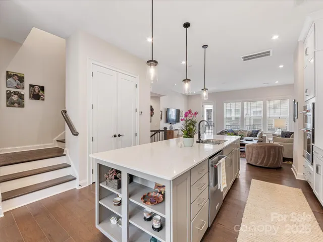a large kitchen with lots of counter space and wooden floor