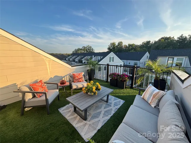 a view of a house with couches chairs and a yard