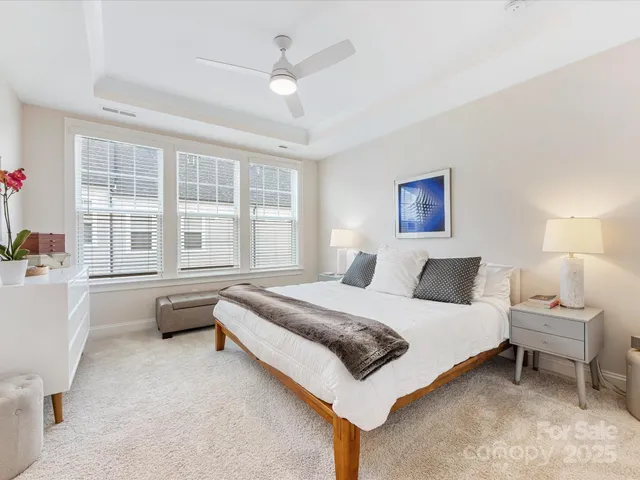 a bedroom with a bed wooden floor and window