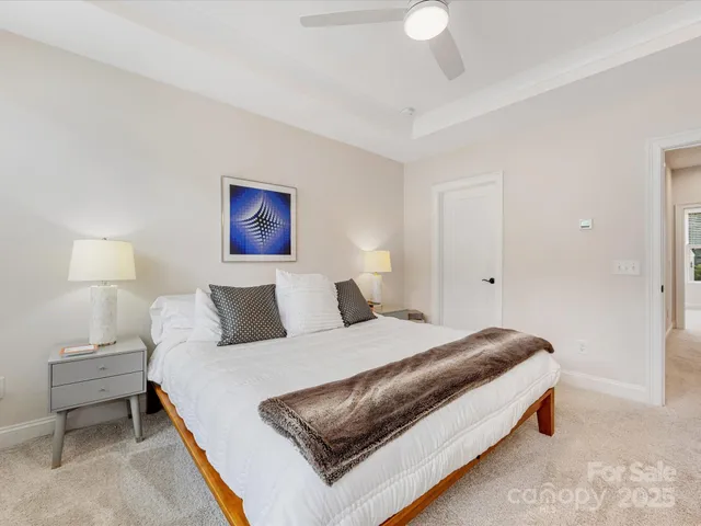 a bedroom with a bed and a lamp