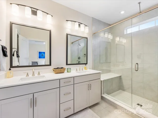 a bathroom with double sink and a mirror