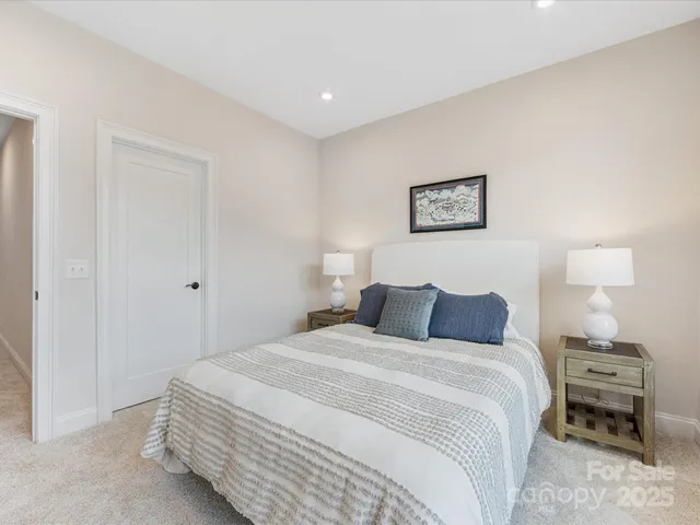 a bedroom with a bed and a lamp