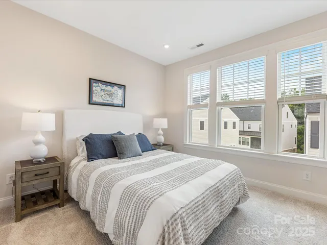 a bedroom with a bed and a large window