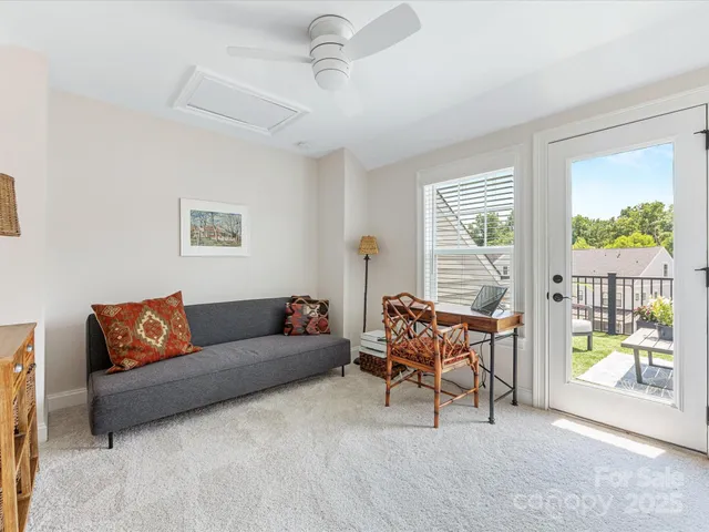 a living room with furniture and a table with wooden floor