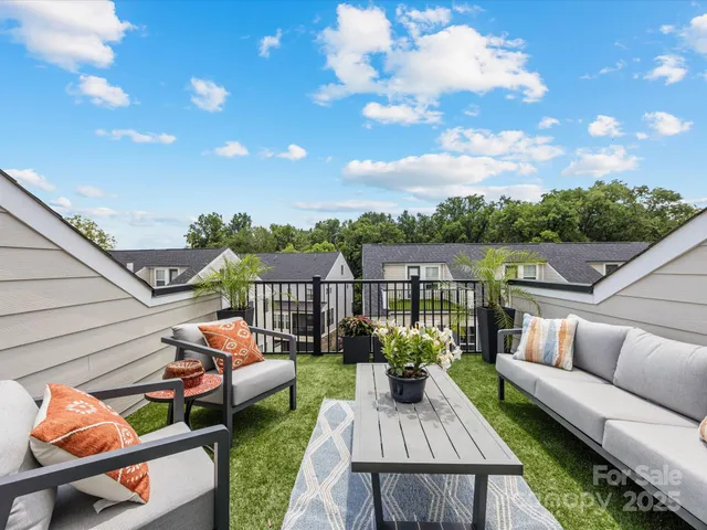 a view of a roof deck with couches fire pit and a barbeque grill with dining table and chairs