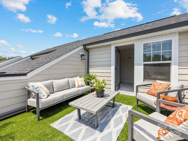 a balcony with furniture and a garden