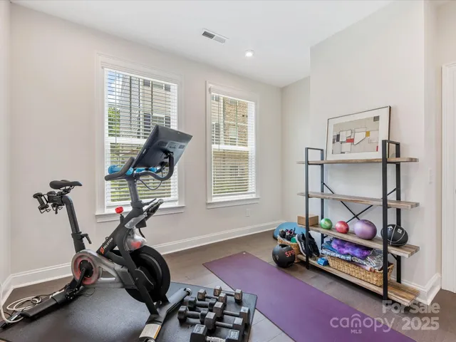 a room with gym equipment and a window