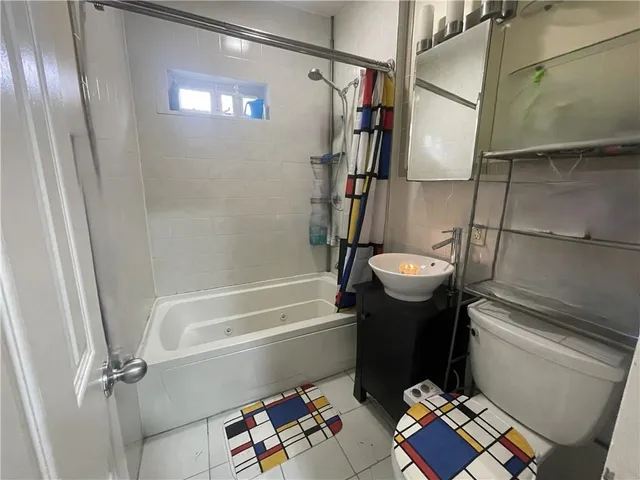 a bathroom with a sink a toilet and mirror