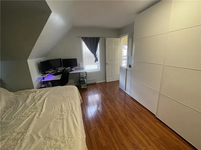 a balcony with wooden floor and yard in the back