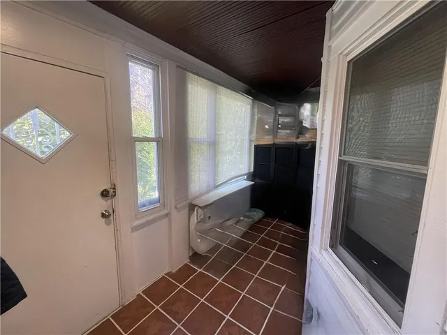 a living room with furniture and a stair