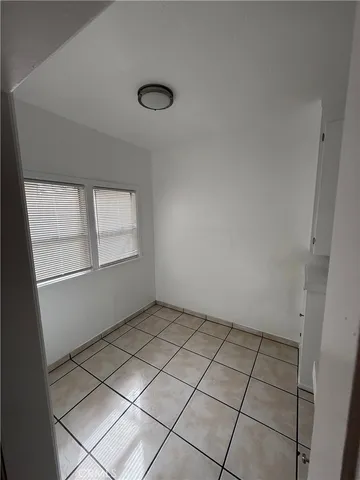 a kitchen with white cabinets and appliances