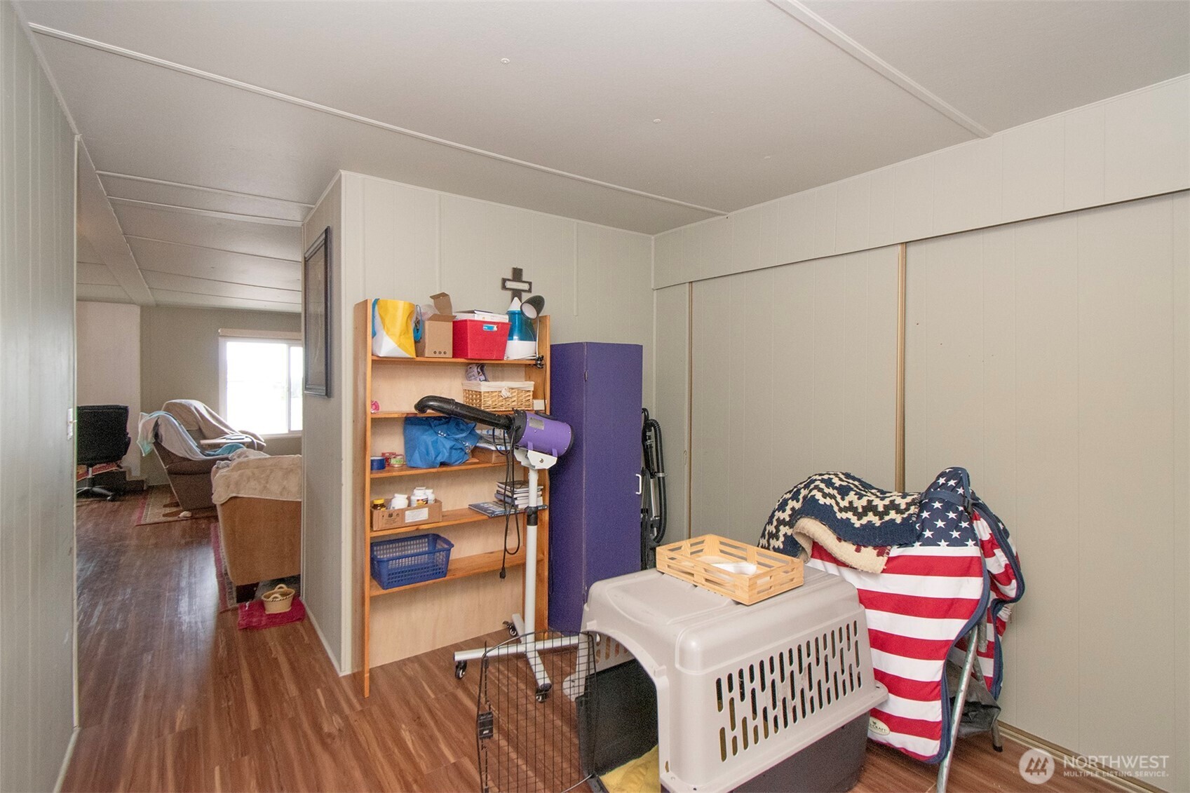 921 South 3rd Avenue, Unit 7 Sequim, WA 98382 - Photo 15 of 32 a bedroom with a bed and a wooden floor