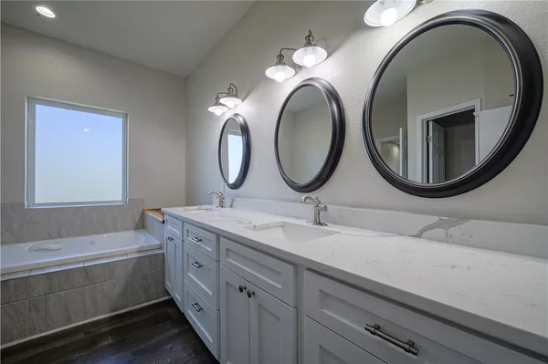 a bathroom with a double vanity sink and a mirror