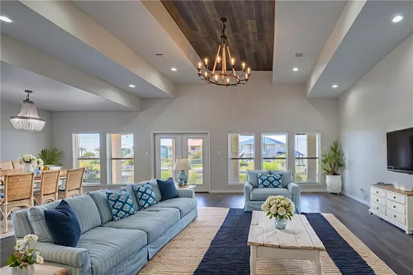 a living room with furniture wooden floor and a flat screen tv