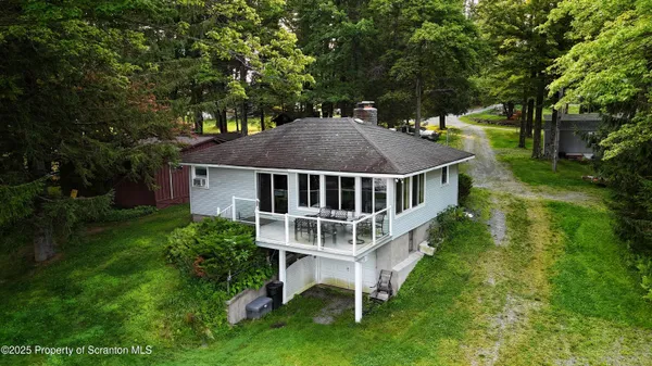 a view of a house with a yard deck and sitting area