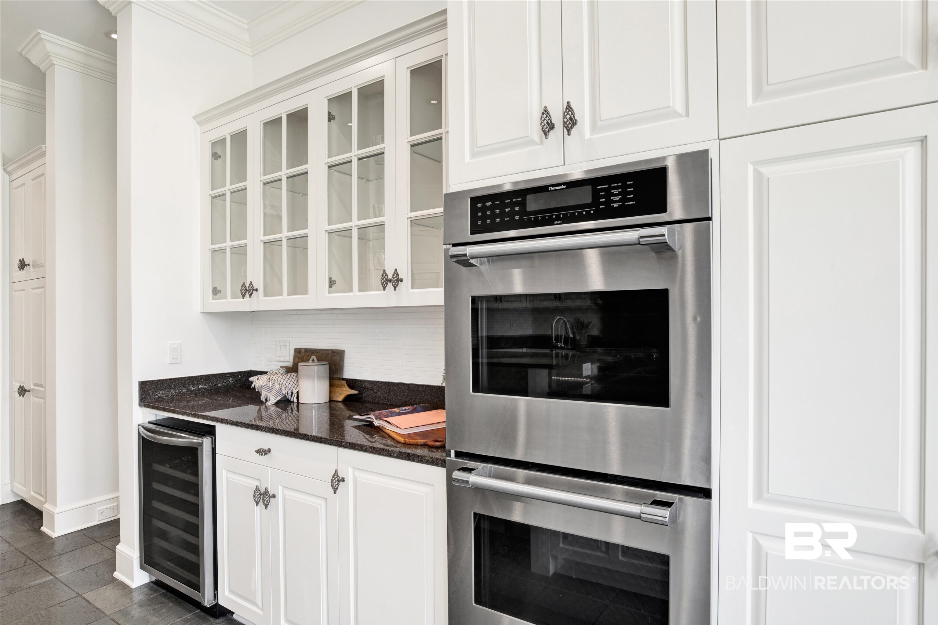 3816 Austill Lane Mobile, AL 36608 - Photo 25 of 80 Kitchen featuring double oven, beverage cooler, white cabinets, glass insert cabinets, and dark stone countertops