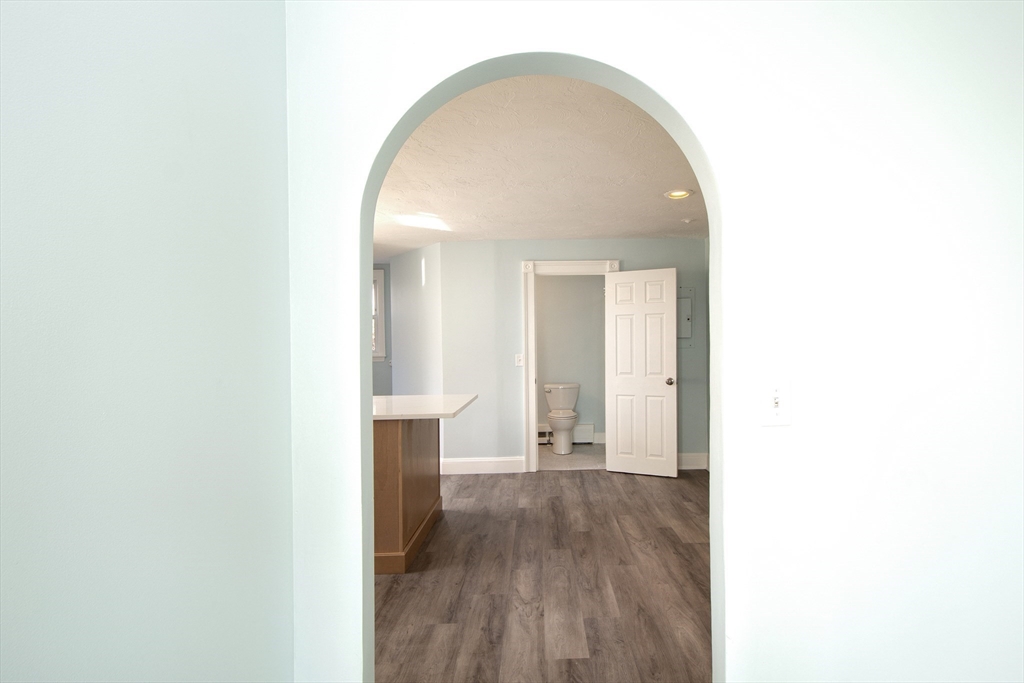 7 Whitehead Avenue, Unit 1 Hull, MA 02045 - Photo 13 of 32 a view of a room with wooden floor and bench