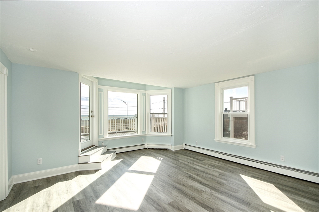 7 Whitehead Avenue, Unit 1 Hull, MA 02045 - Photo 15 of 32 a view of a room with wooden floor and windows